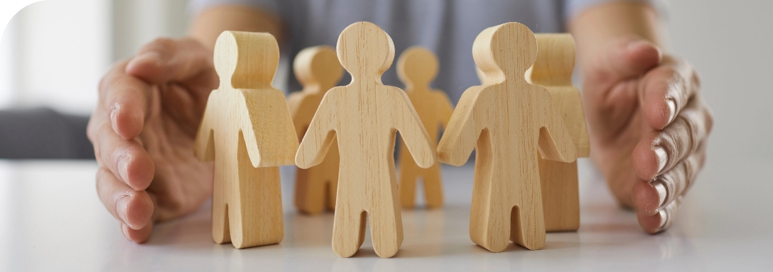 Wooden figurines of people arranged in a circle