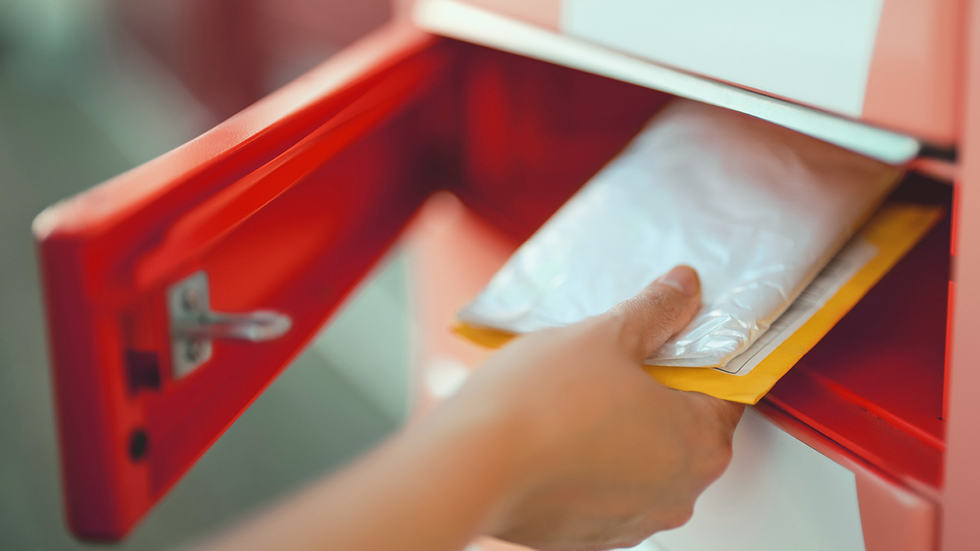 Featured Image Hand removing the letters from the mailbox